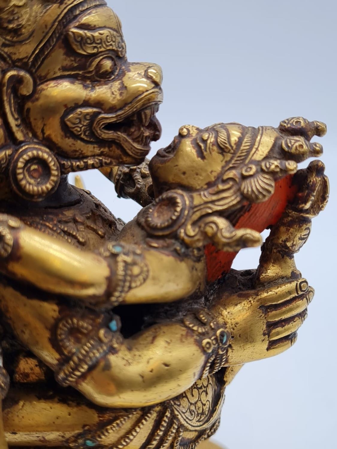 A very early Oriental gilt on bronze statue of a fertility god, weight