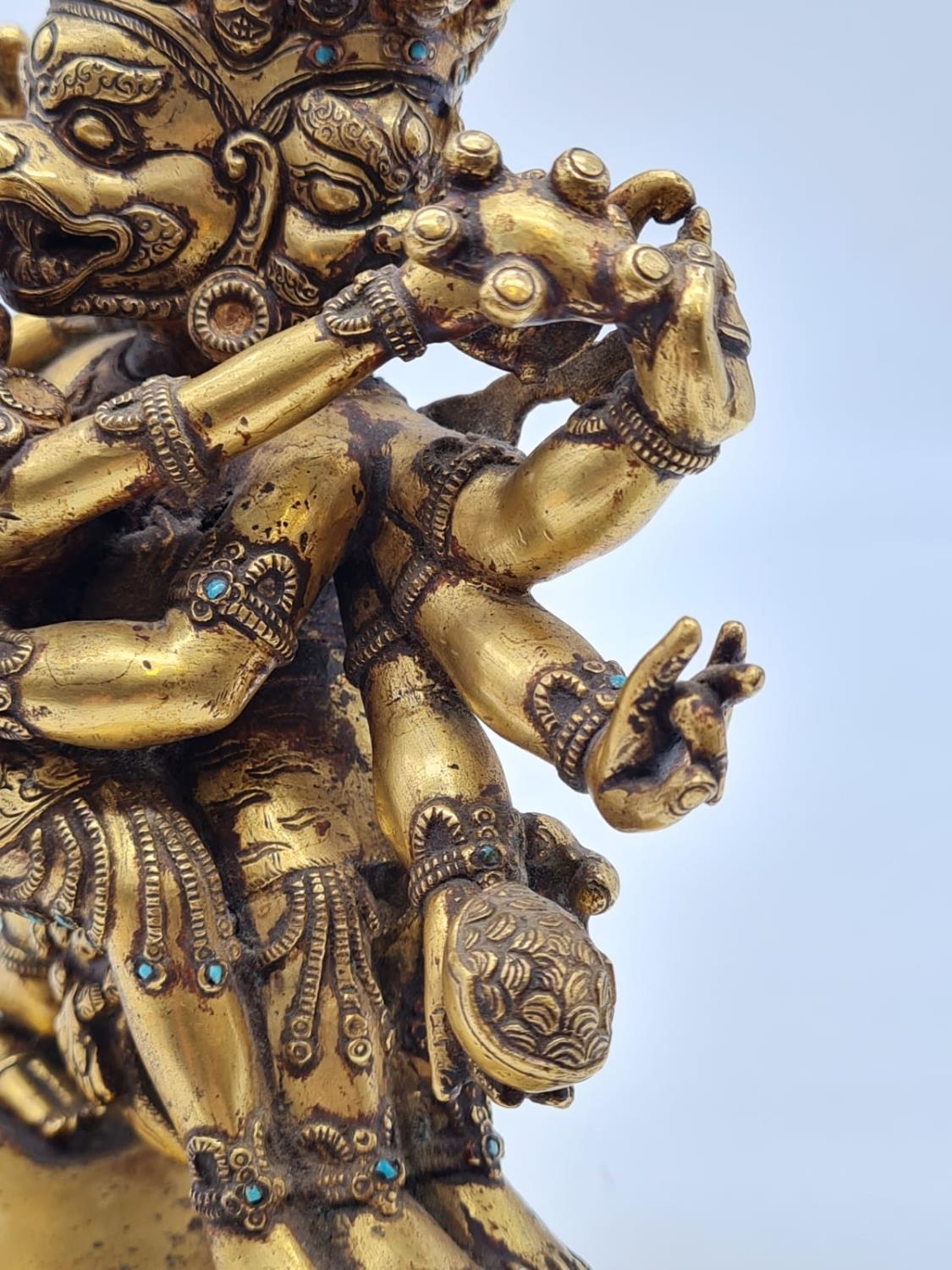 A very early Oriental gilt on bronze statue of a fertility god, weight