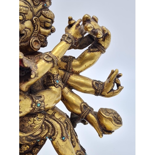 A very early Oriental gilt on bronze statue of a fertility god, weight
