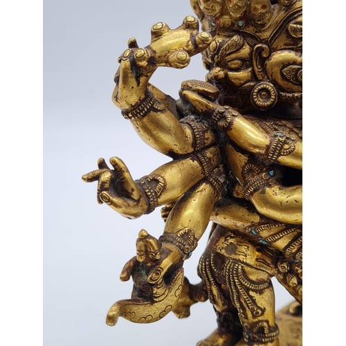 A very early Oriental gilt on bronze statue of a fertility god, weight