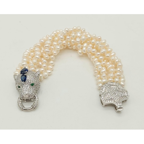 56 - A magnificent, seven row, white pearl, bracelet, with an impressive Cartier Panther style clasp. Per... 