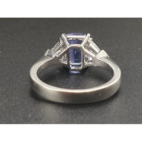 12 - A BEAUTIFUL 2CT CUSHION CUT SAPPHIRE CENTRE STONE FLANKED BY TWO LARGE TRIANGULAR DIAMONDS SET IN 18... 