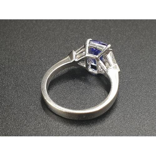 12 - A BEAUTIFUL 2CT CUSHION CUT SAPPHIRE CENTRE STONE FLANKED BY TWO LARGE TRIANGULAR DIAMONDS SET IN 18... 