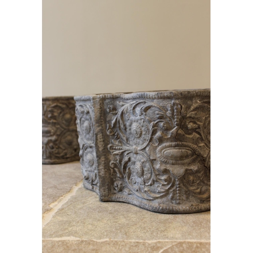 654 - A pair of George III style lead planters, of scalloped form, cast in relief with scrolling foliate a... 