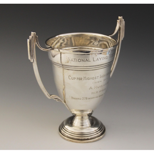 3 - A George VI silver twin-handled trophy cup, tapering bowl on stepped circular foot with angular hand... 