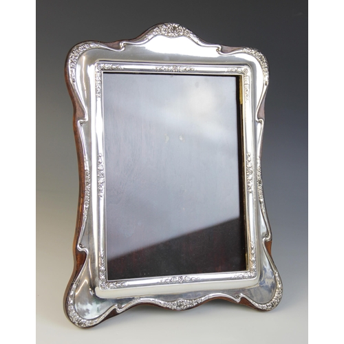 11 - A George V silver mounted photograph frame, J & R Griffin Ltd, Chester 1913, the flowing rectangular... 