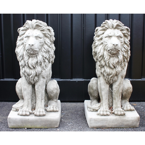 585 - A pair of heavy reconstituted stone garden lion statues, late 20th century, each modelled seated upo... 