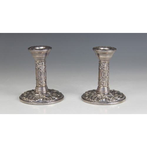 23 - A pair of silver mounted desk candlesticks, Broadway & Co, Birmingham 1972, cylindrical columns on w... 