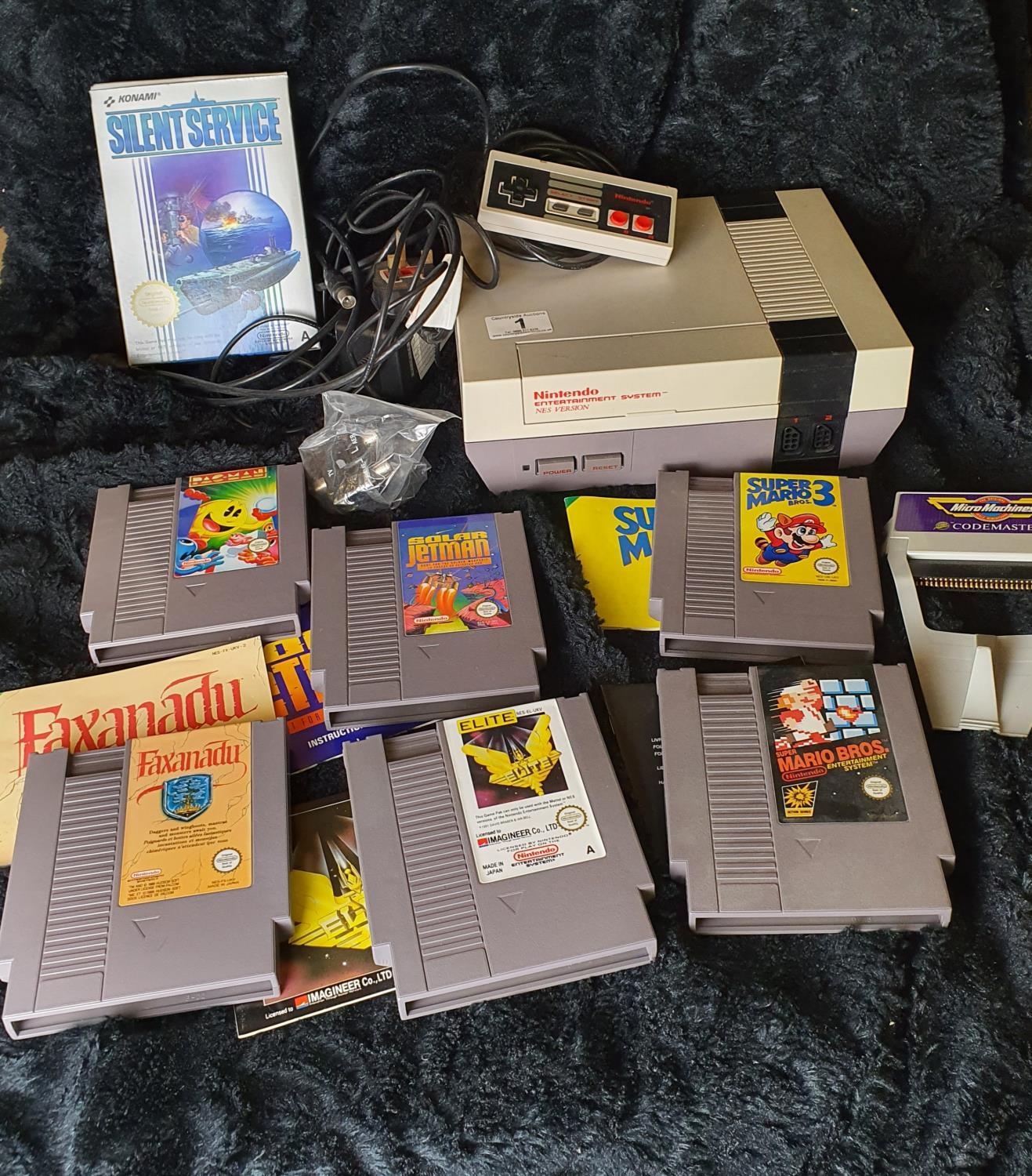 Vintage Nintendo games console with a selection of games