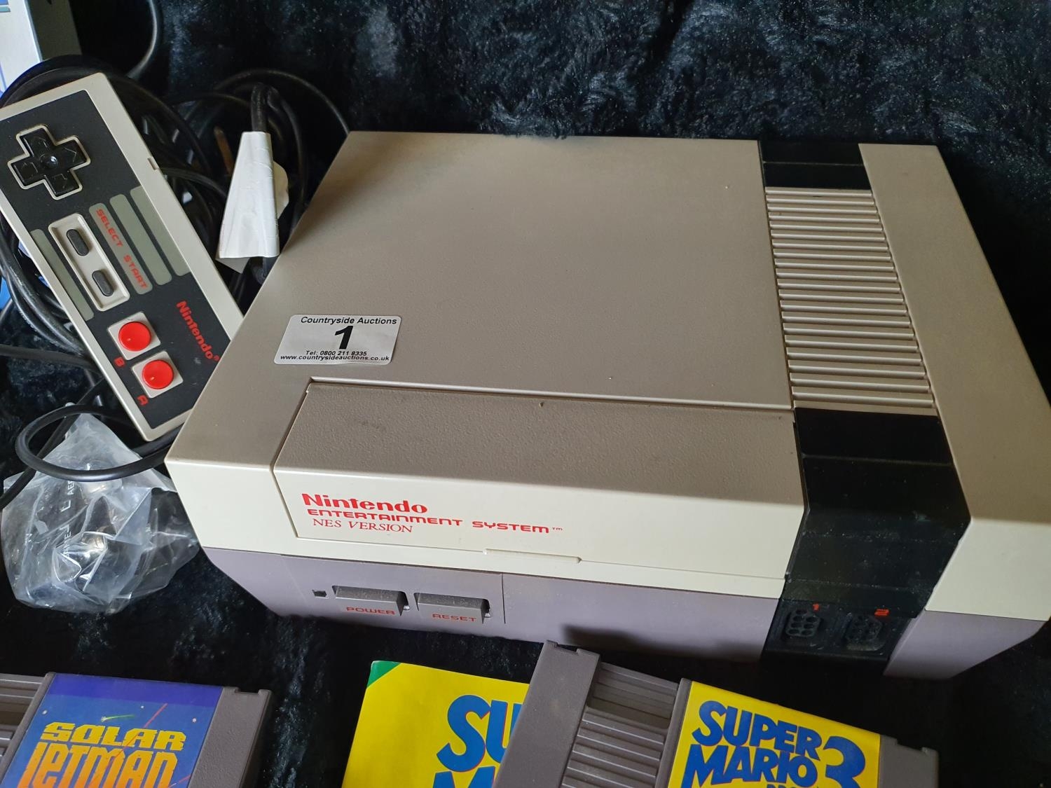 Vintage Nintendo games console with a selection of games