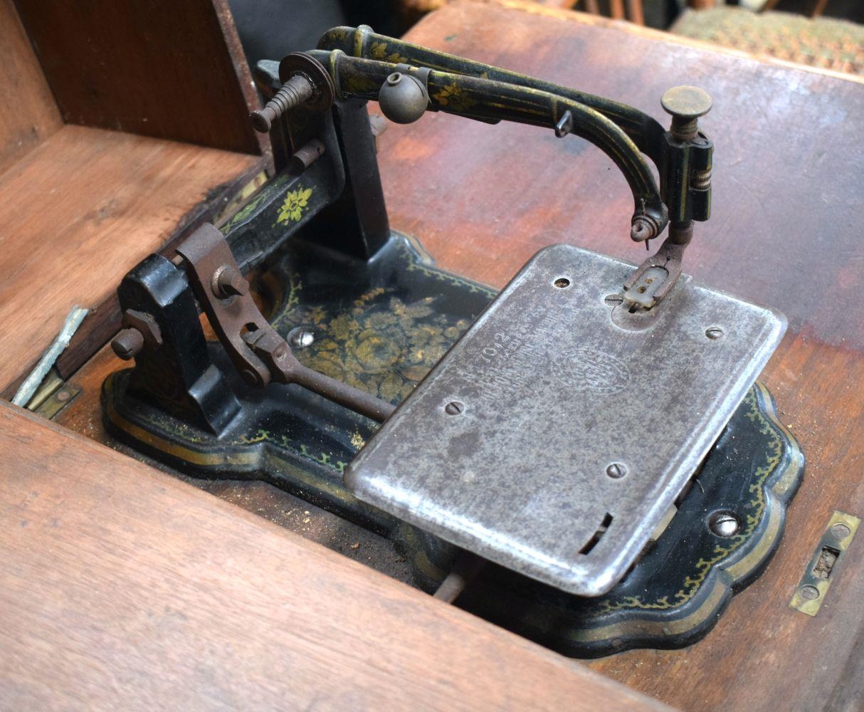 AN UNUSUAL ANTIQUE SEWING MACHINE with double pedal mechanism. 90 cm x