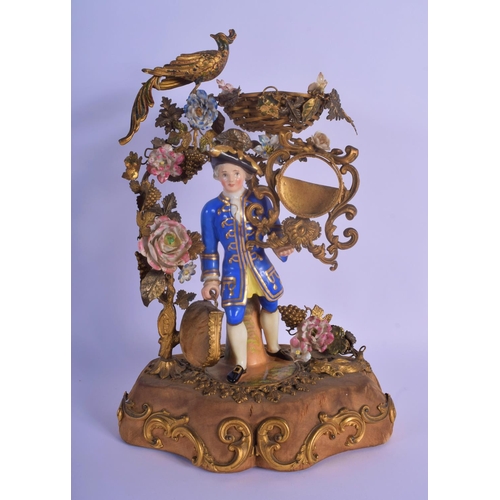 26 - A RARE EARLY 19TH CENTURY FRENCH PARIS PORCELAIN AND GILT METAL FIGURE modelled as a male holding a ... 