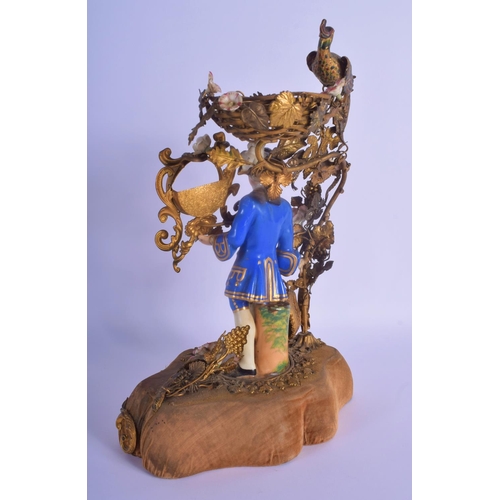 26 - A RARE EARLY 19TH CENTURY FRENCH PARIS PORCELAIN AND GILT METAL FIGURE modelled as a male holding a ... 