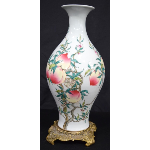 3191 - A Chinese porcelain famille rose vase decorated with peaches and bats. Together with a gilt bronze s... 