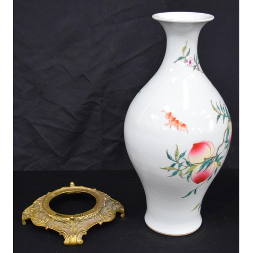 3191 - A Chinese porcelain famille rose vase decorated with peaches and bats. Together with a gilt bronze s... 