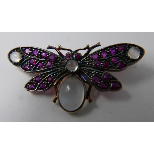 12 - A yellow gold butterfly brooch studded with rubies and four moonstone cabochons, 1.5 x 3.5cm, 3.4g