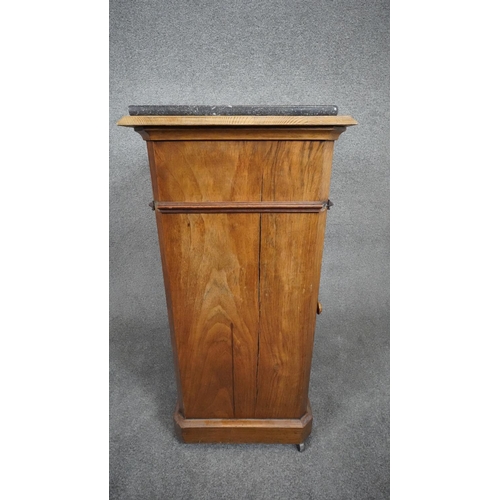 27 - A late 19th century French walnut pedestal cabinet with marble top above frieze drawer and panel doo... 