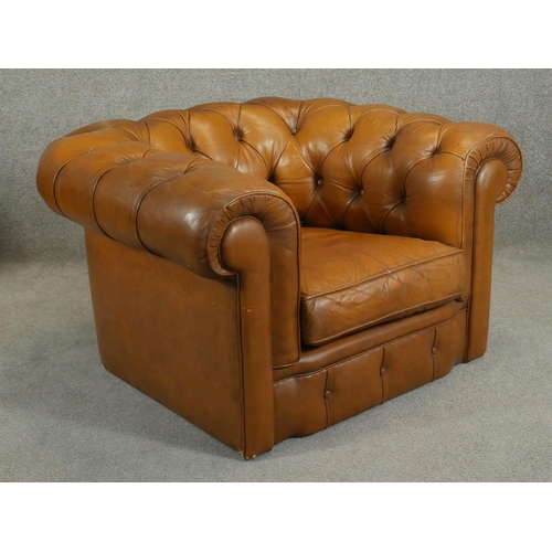 187 - A pair of deep buttoned leather upholstered Chesterfield armchairs. H.65cm