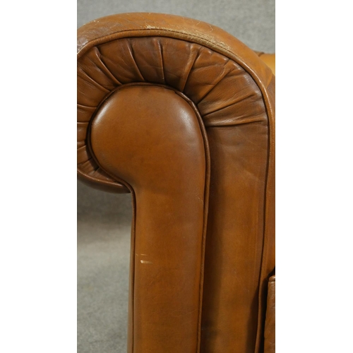 187 - A pair of deep buttoned leather upholstered Chesterfield armchairs. H.65cm