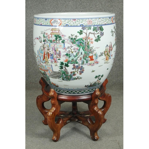 200 - A 20th century Chinese Famille Verte porcelain jardiniere on carved hardwood stand. Decorated with a... 