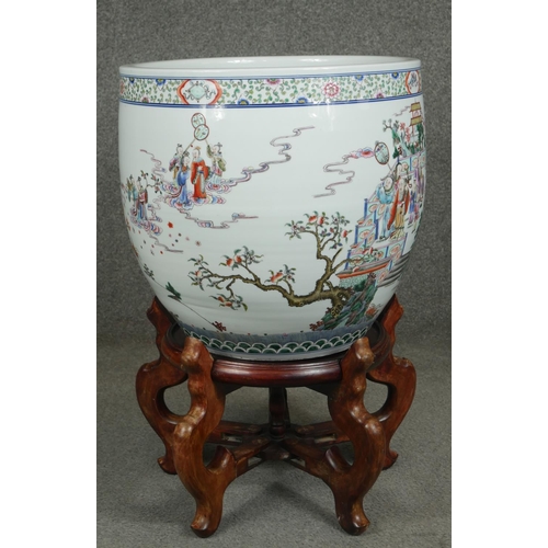 200 - A 20th century Chinese Famille Verte porcelain jardiniere on carved hardwood stand. Decorated with a... 