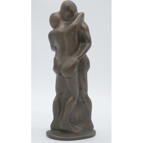 218 - A bronze effect resin sculpture of an embracing couple. Monogrammed ST. H.29cm