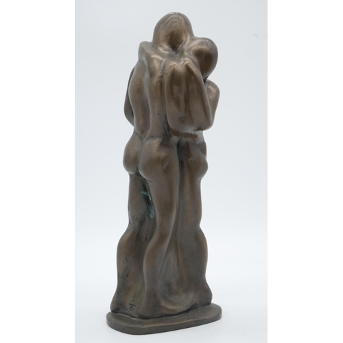218 - A bronze effect resin sculpture of an embracing couple. Monogrammed ST. H.29cm