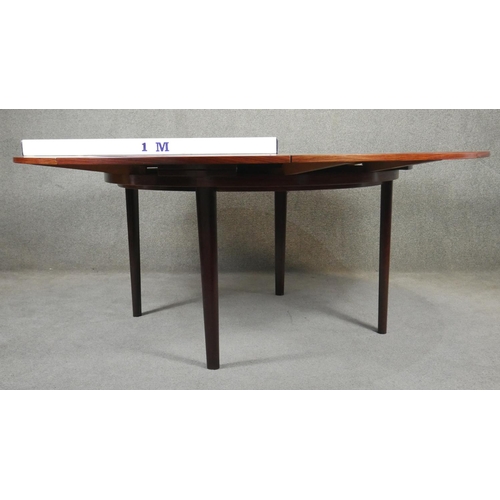 33 - A vintage Dyrland Lotus 'flip flap' table with pull out folding arc extensions. H.72 D.128 D.180cm