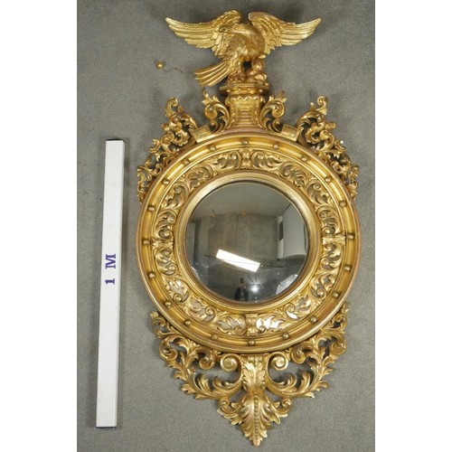 104 - An early 19th century giltwood wall mirror with ho ho bird surmount with suspended ball from its bea... 