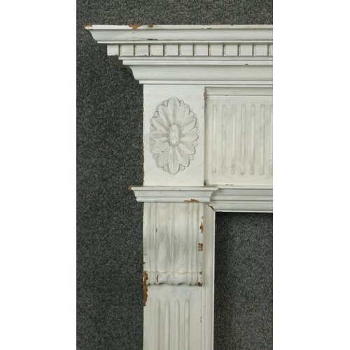 105 - A carved and painted Adam style fire surround with floral swag decoration to the frieze. H.120 W.133... 