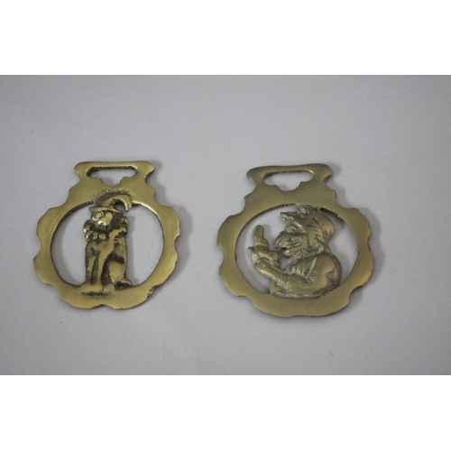 193 - A framed painted plastic tile effect picture of Punch and Judy along with two horse brasses and fire... 