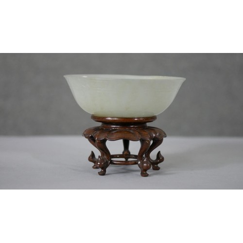 199 - A 20th century Chinese carved celadon jade bowl and stand along with a carved jade plaque with pierc... 