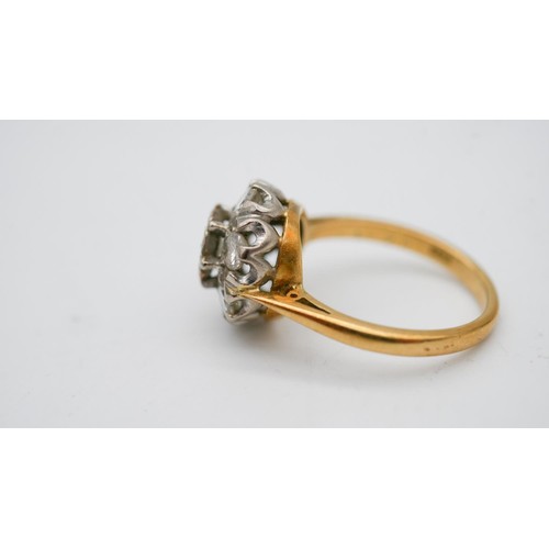 339 - A 18 carat gold and white metal (tested platinum) diamond cluster ring. Set with seven round brillia... 