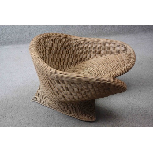 33 - A contemporary shaped wicker armchair. H.40 W.75 W.42 cm