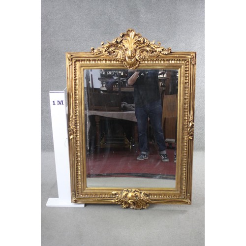 159 - A gilt framed pier mirror with bevelled plate in foliate decorated frame. H.150 W.103 cm.