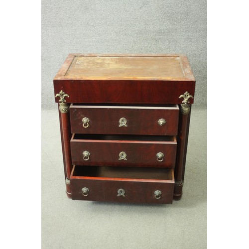 231 - An Empire style ormolu mounted mahogany chest of three long drawers flanked by pilasters on turned f... 