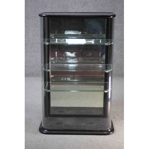 278 - A C.1900 counter top display cabinet with bowed glass in ebonised frame. H.92 W.57 D.29 cm