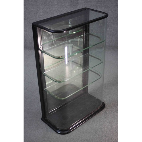 278 - A C.1900 counter top display cabinet with bowed glass in ebonised frame. H.92 W.57 D.29 cm