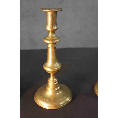 2 - A pair of early 20th century brass candlesticks along with a portable brass candlestick lantern with... 