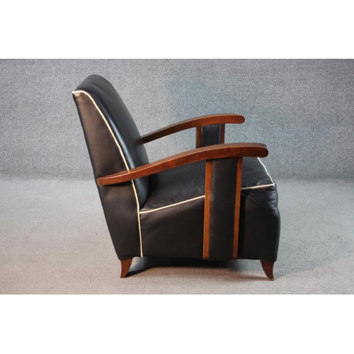 42 - A pair of mid century French Art Deco style beech framed armchairs in piped leather upholstery on sw... 