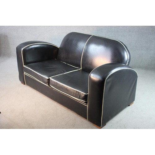 43 - An Art Deco two seater sofa in piped leather upholstery on block supports. H.80 W.170 D.85 cm