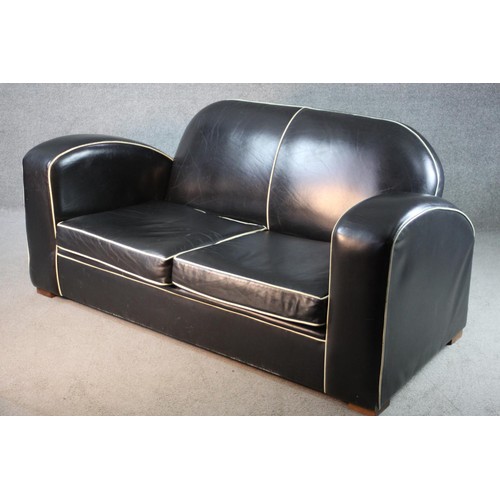 43 - An Art Deco two seater sofa in piped leather upholstery on block supports. H.80 W.170 D.85 cm