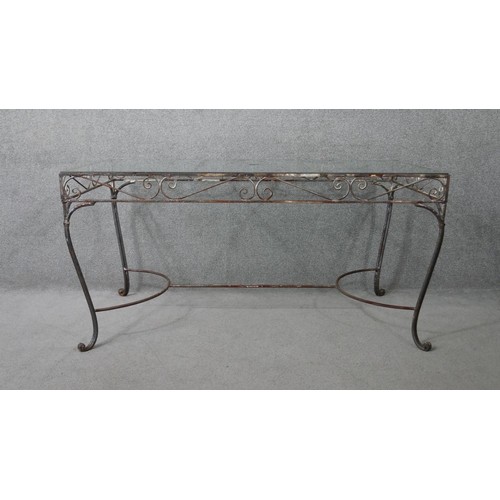282 - A vintage wrought iron garden or conservatory table with plate glass top. H.76 W.153 D.76cm