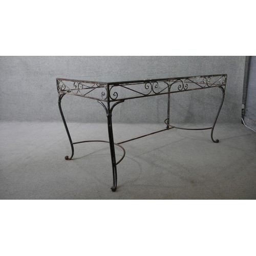 282 - A vintage wrought iron garden or conservatory table with plate glass top. H.76 W.153 D.76cm