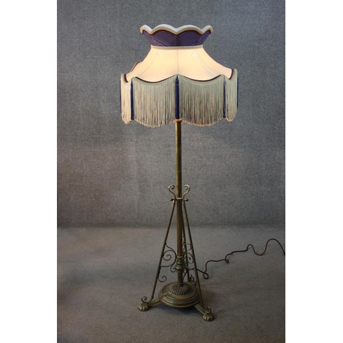 132 - Lamp standard, 19th century brass converted to electricity with original fringed shade along with an... 