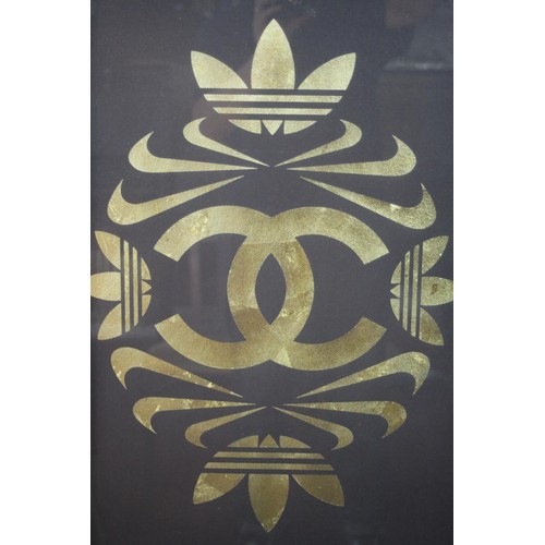 383 - A framed and glazed print on cloth, a composition from the Adidas, Nike and Chanel logos. H.73 W.53 ... 