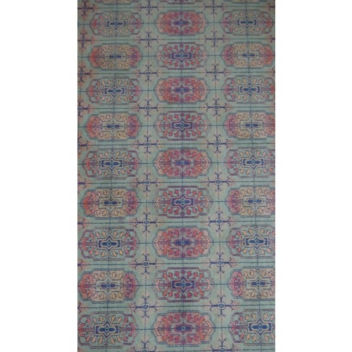 6 - A Bokhara motif rug on a green ground within multiple borders. L.200 W.140 cm