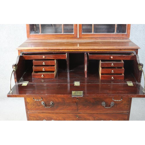 224 - A Chippendale style mahogany secretaire bookcase, with a blind fret cornice over a pair of astragal ... 