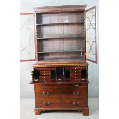 224 - A Chippendale style mahogany secretaire bookcase, with a blind fret cornice over a pair of astragal ... 