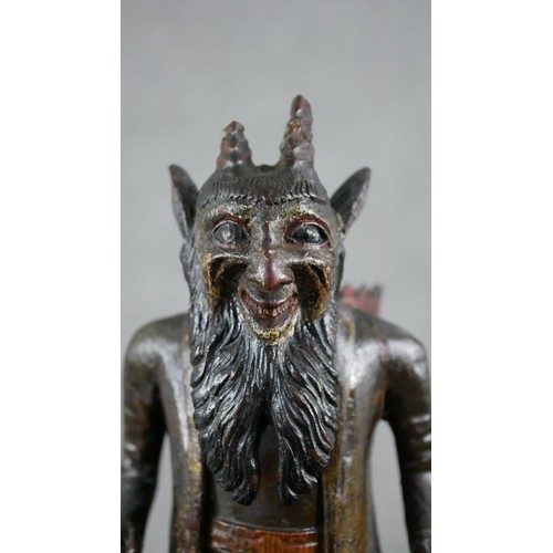 5 - A 19th century carved black forest faun match holder, a pedestal base with red basket on his back. H... 